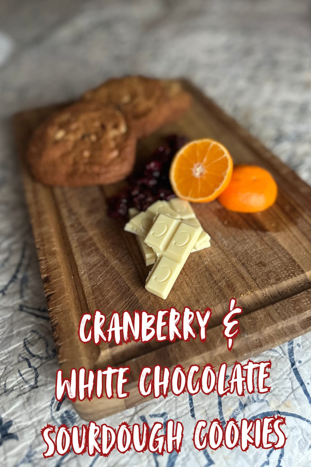 oranges, white chocolate, crab raisins, on a. cutting board with sourdough cookies