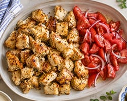 roasted greek chickens bites served with greek style tomato salad