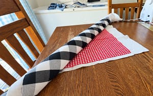 Quilt layers rolled to fit beside the sewing machine needle.