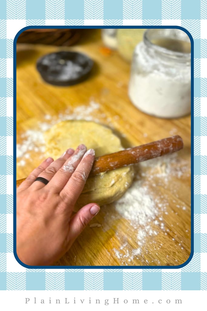 a small rolling pin, rolling out pastry dough on a floured counter