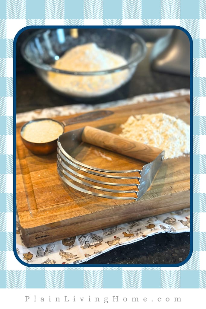 a pastry cutter to cut butter into the flour to make biscuits dough
