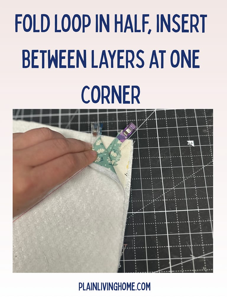hanging loop inserted between the quilted panels of the hot pad