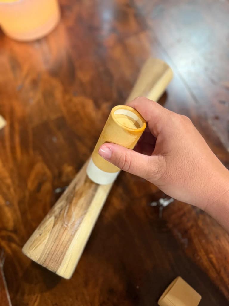 Applying cutting board balm to a wooden sauerkraut packer