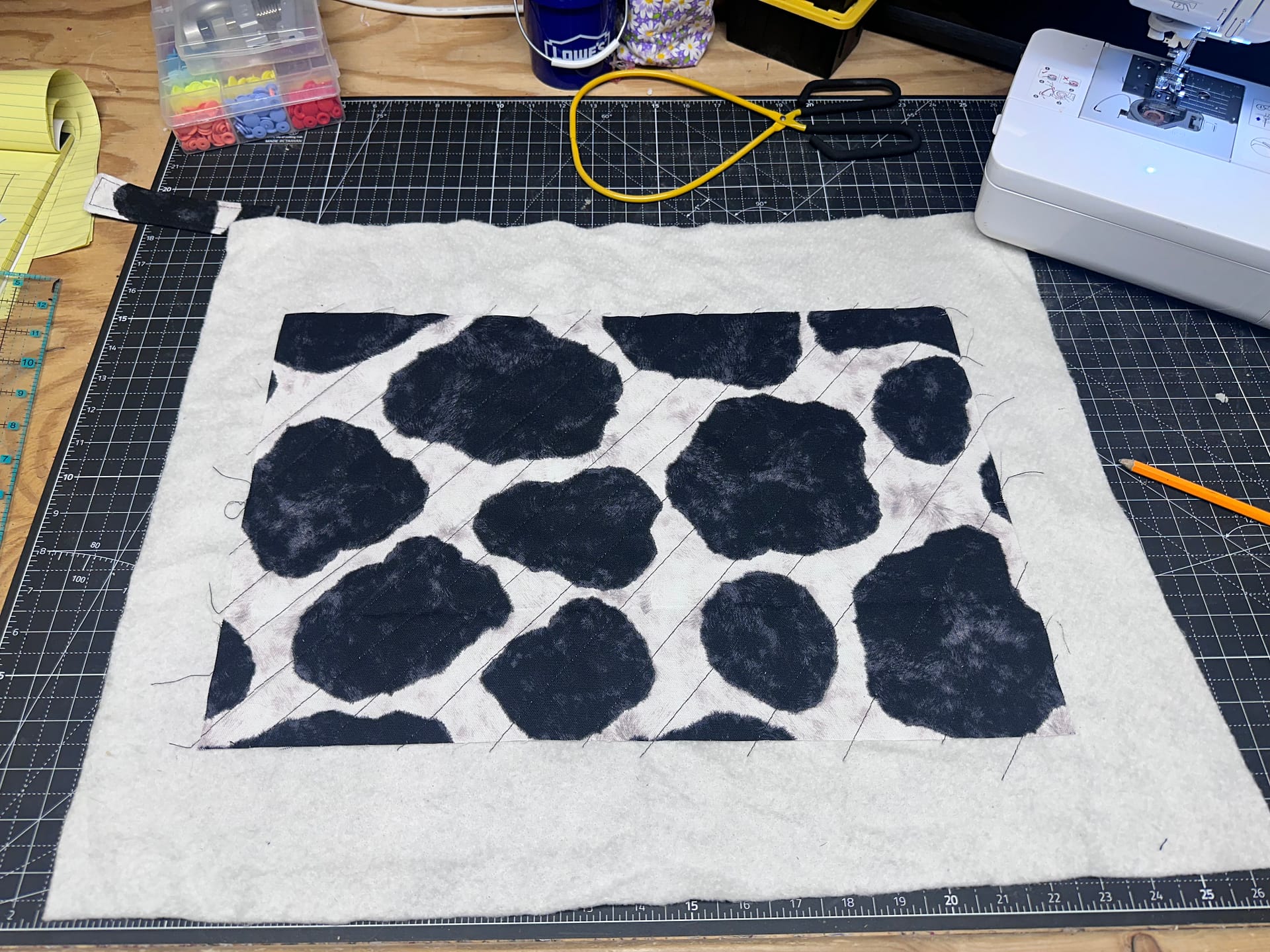 Quilted fabric and batting trimmed for a book sleeve pattern