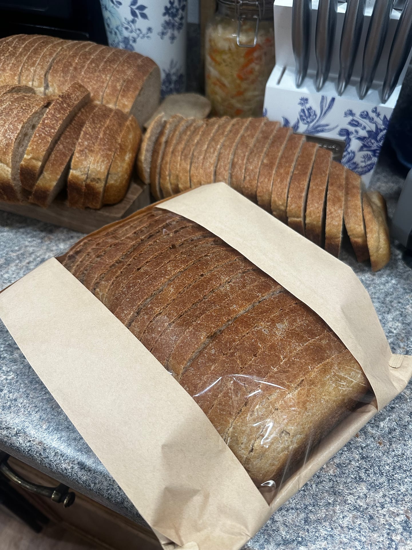 homemade sourdough sandwich bread packaged in a Kraft paper bag to take to a farmers market party 