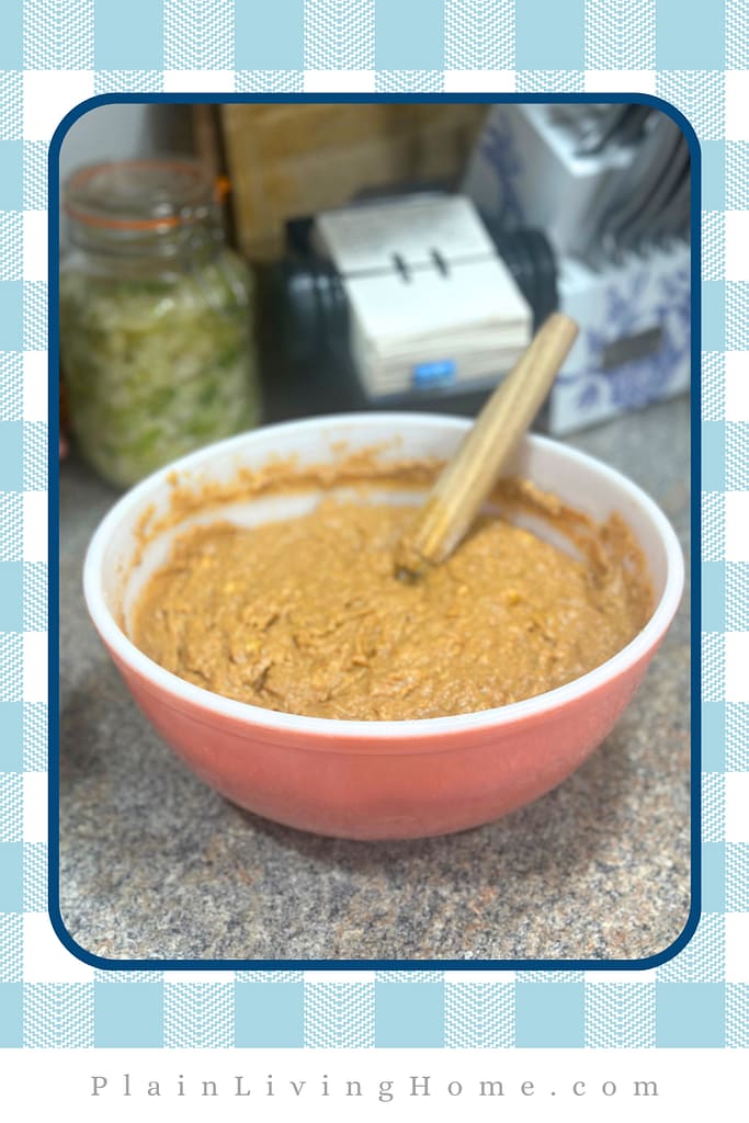 banana muffins batter all mixed up adn resting to absorb the liquid into the fresh milled flour