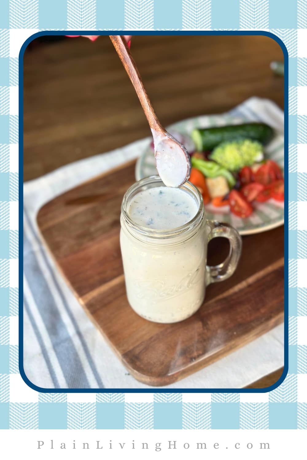 homemade ranch dressing served on a rustic cutting board is a mason jar