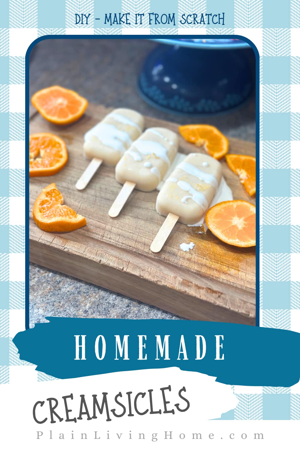 orange creamsicle popsicles drizzled with heavy cream and served with fresh slices of orange