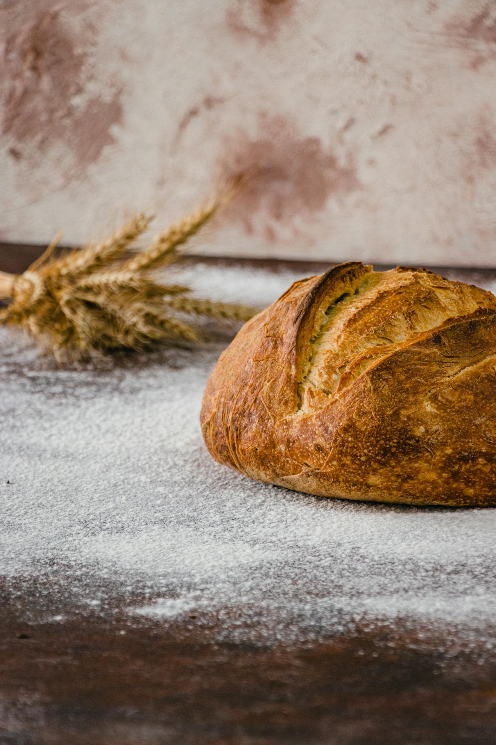 An artisan loaf amidst scattered flour, capturing the essence of rustic baking.