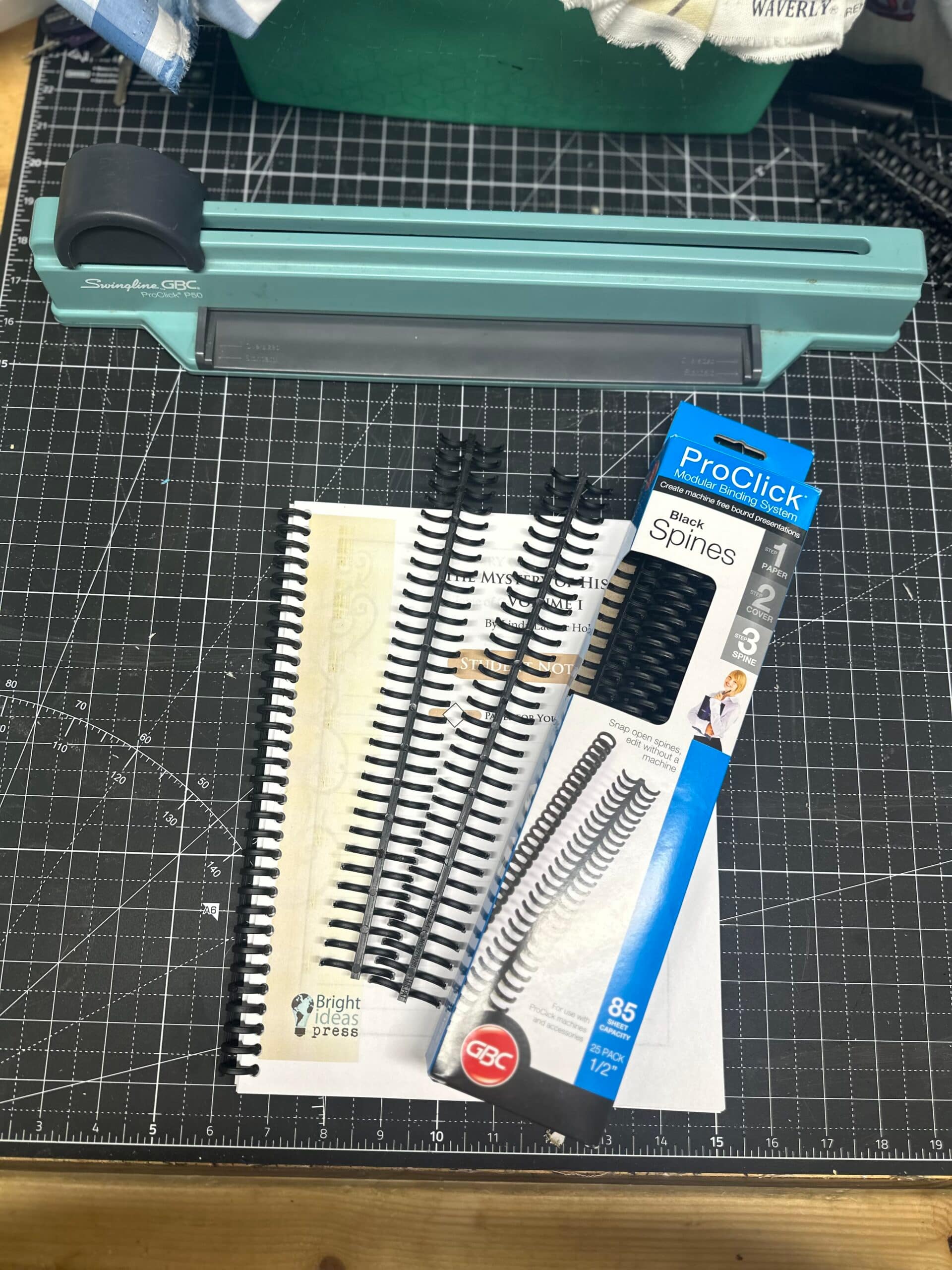 a GBC pro click binding machine with combs and a finished bound workbook