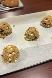 cookie dough scoops on a parchment lined baking tray