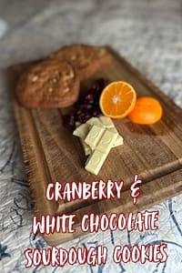 oranges, white chocolate, crab raisins, on a. cutting board with sourdough cookies