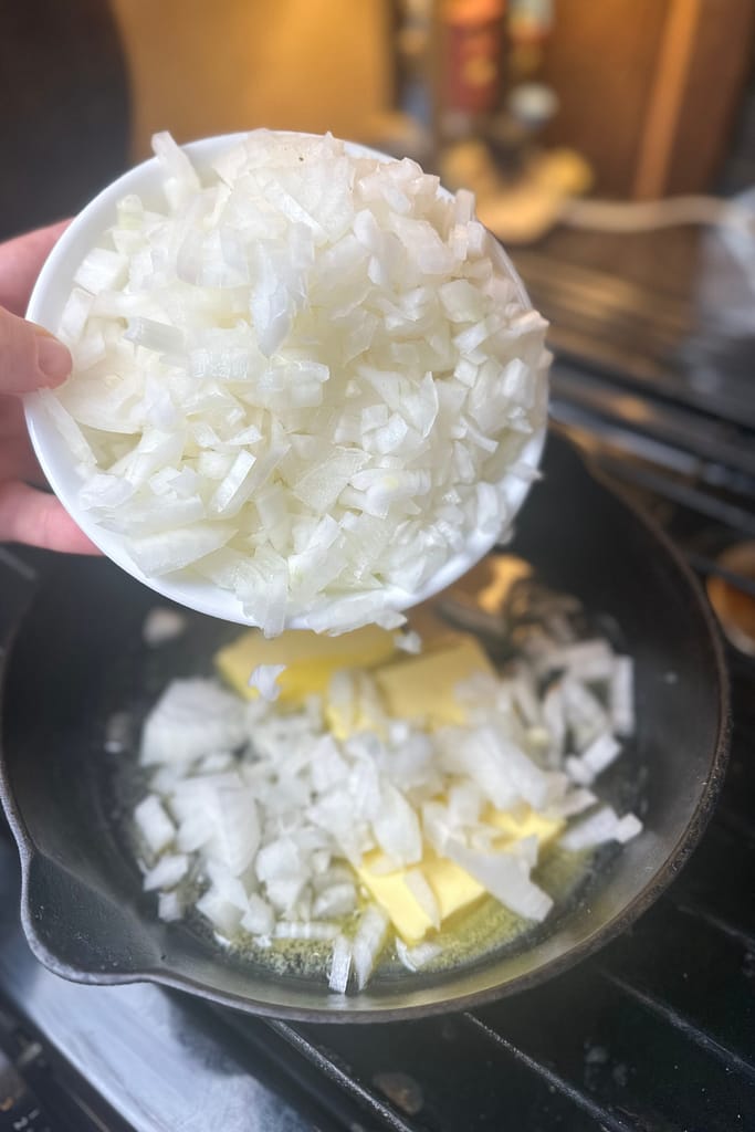 diced onions going into a skillet to caramelize
