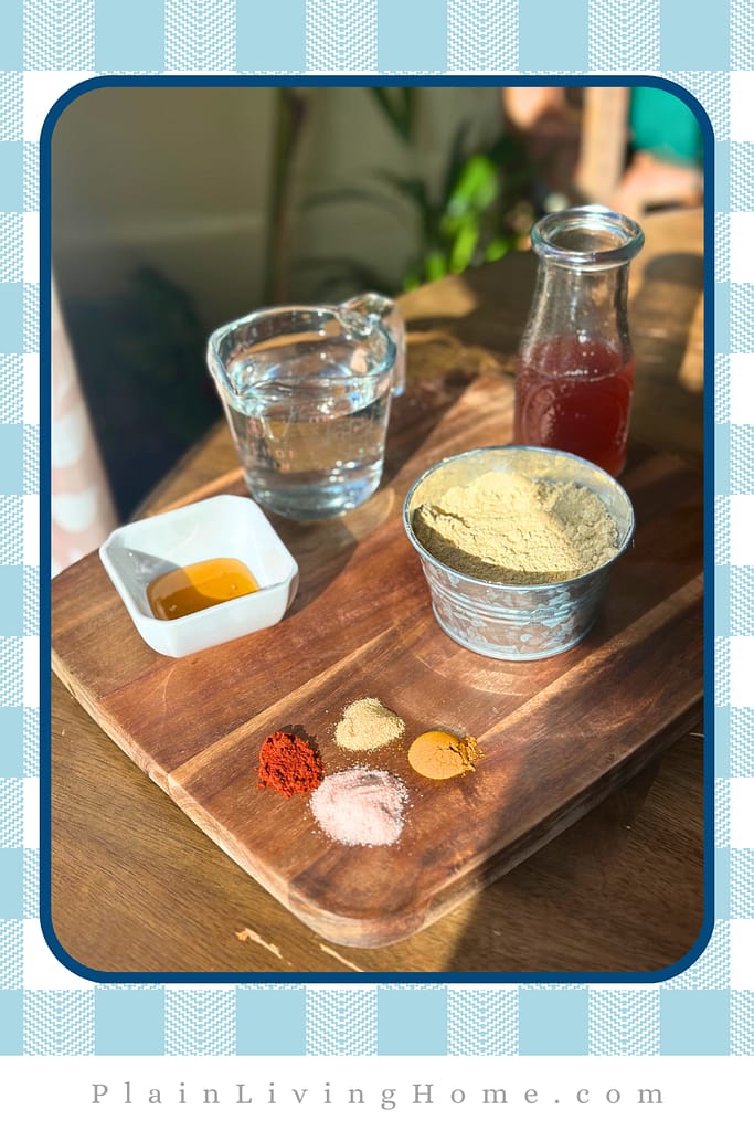 ingredients to make mustard from scratch, neatly arranged on a tray, in the twilight coming through a kitchen window