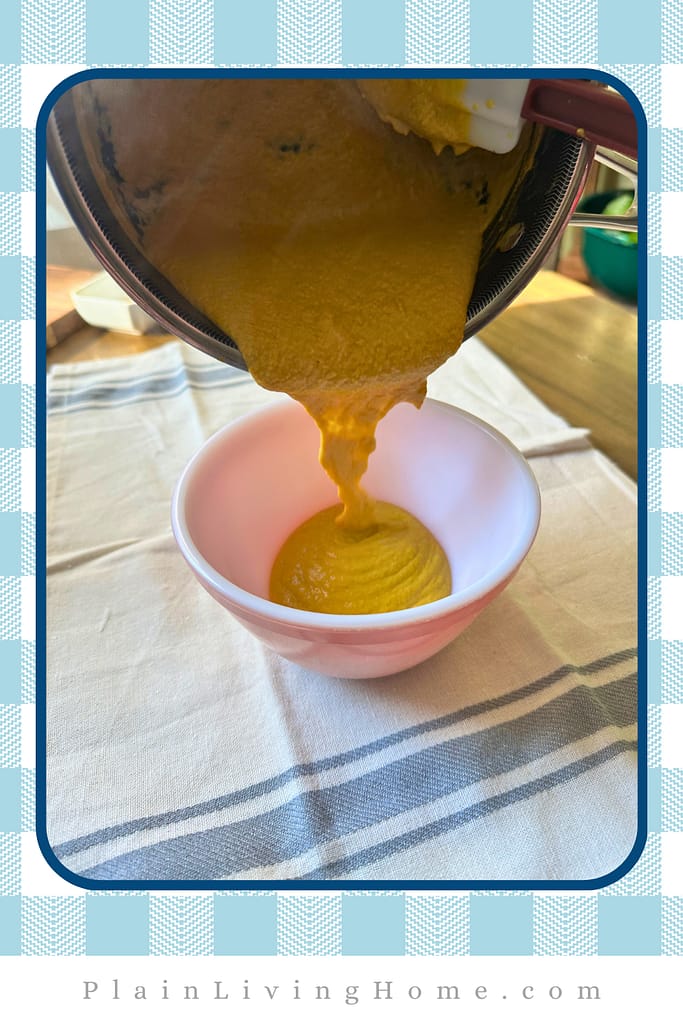 pouring the cooked mustard into a small bowl to cool off