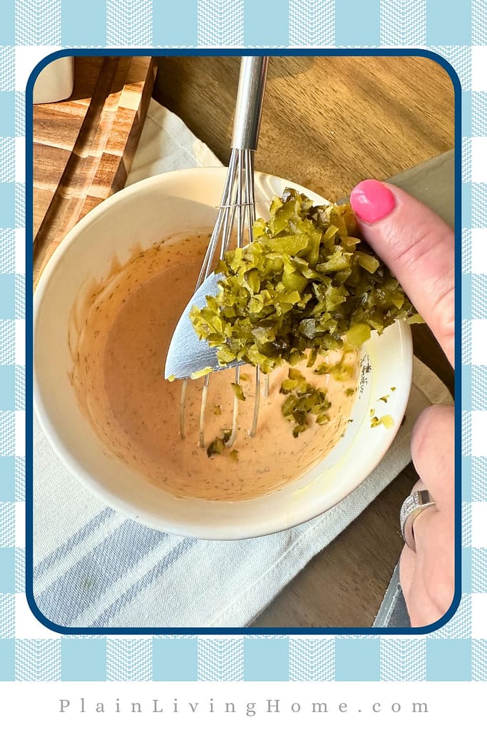 adding pickles into the other ingredients for a homemade dressing