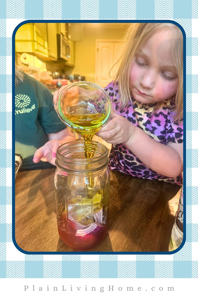 pouring olive oil into a jar to make red onion dressing