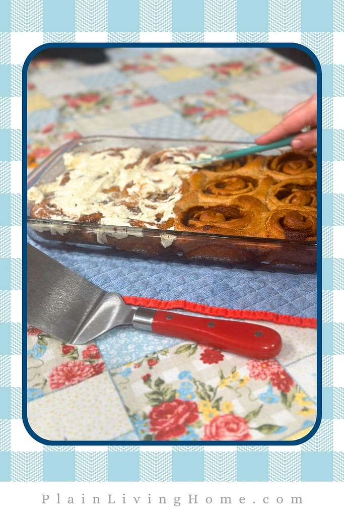 delicious buttercream icing over warm fresh milled cinnamon rolls