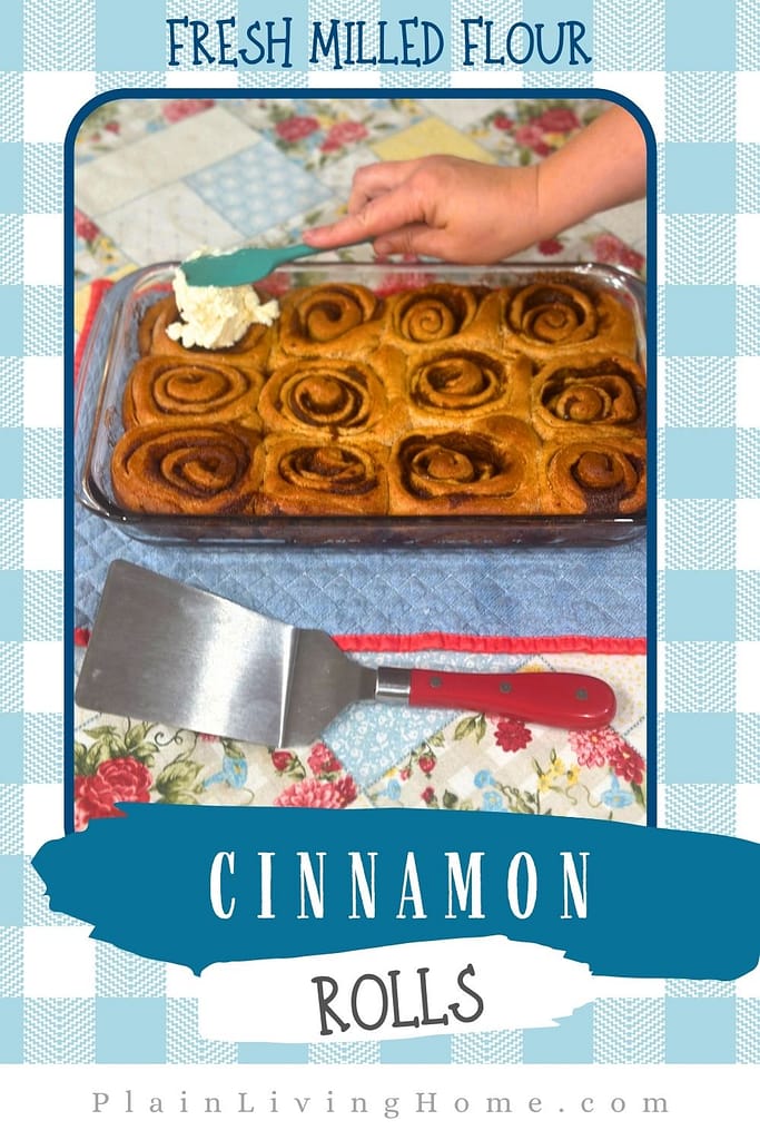 spreading icing on fresh milled cinnamon rolls