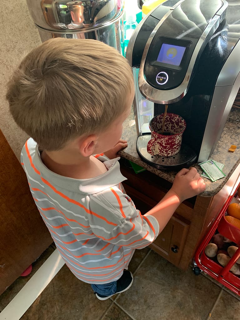 Seth making coffee in the camper