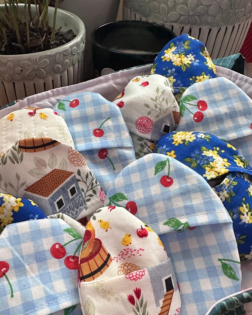 fabric easter eggs stacked in a handmade quilted basket