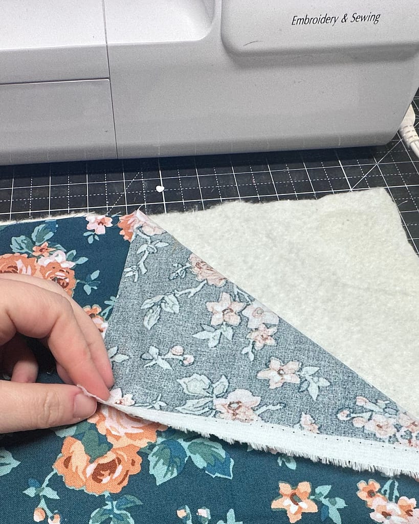 a layer of cotton fabric on top of quilt batting
