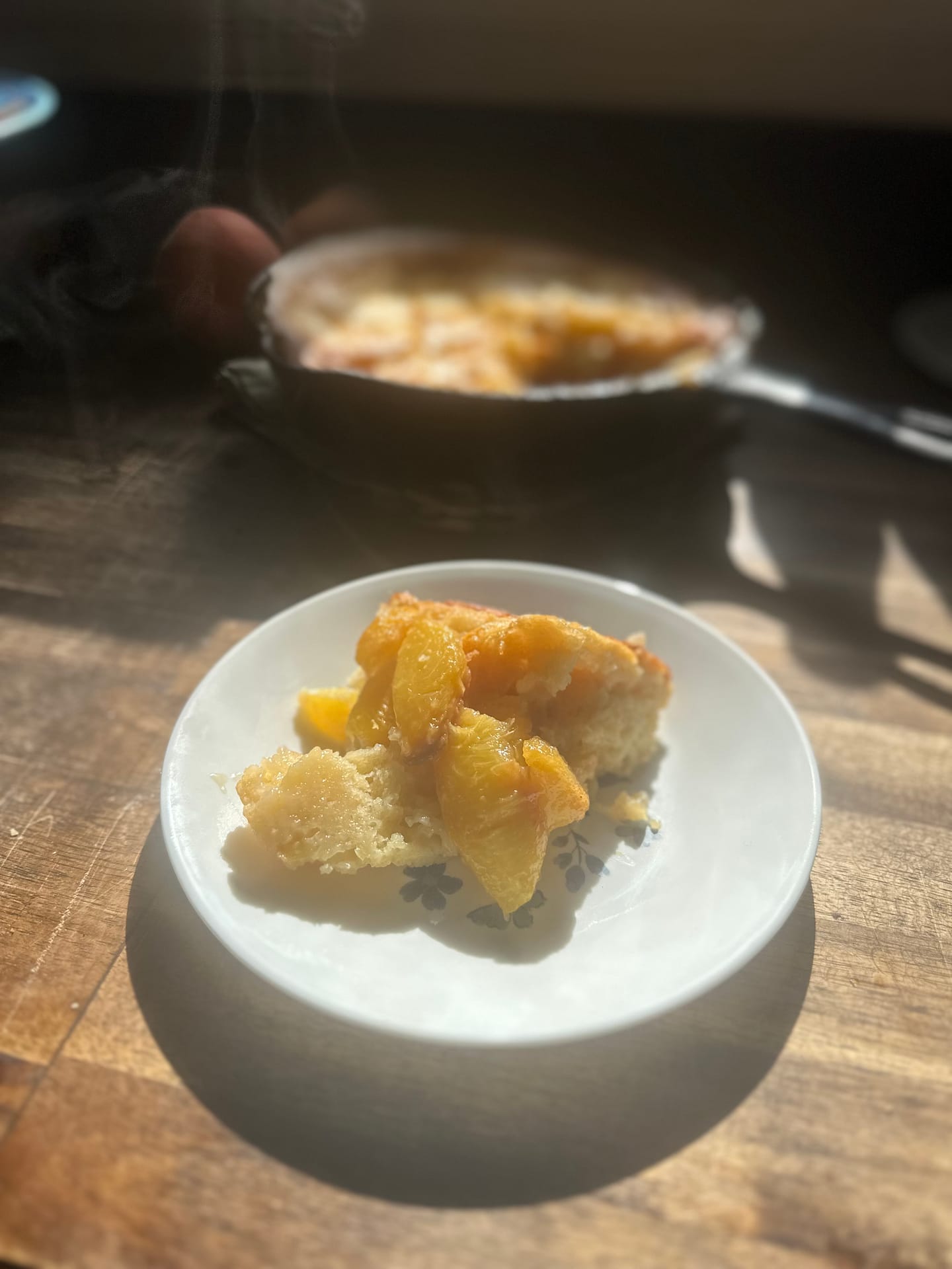 fresh peach cobbler served on a coreele dinner plate